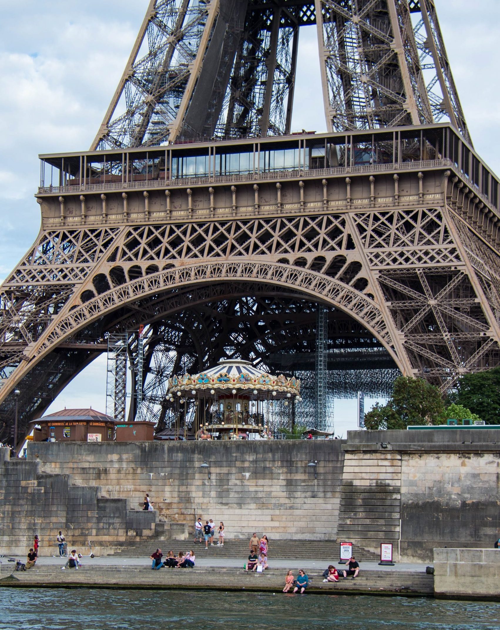 Eiffel Tower with Parisians on the river bank