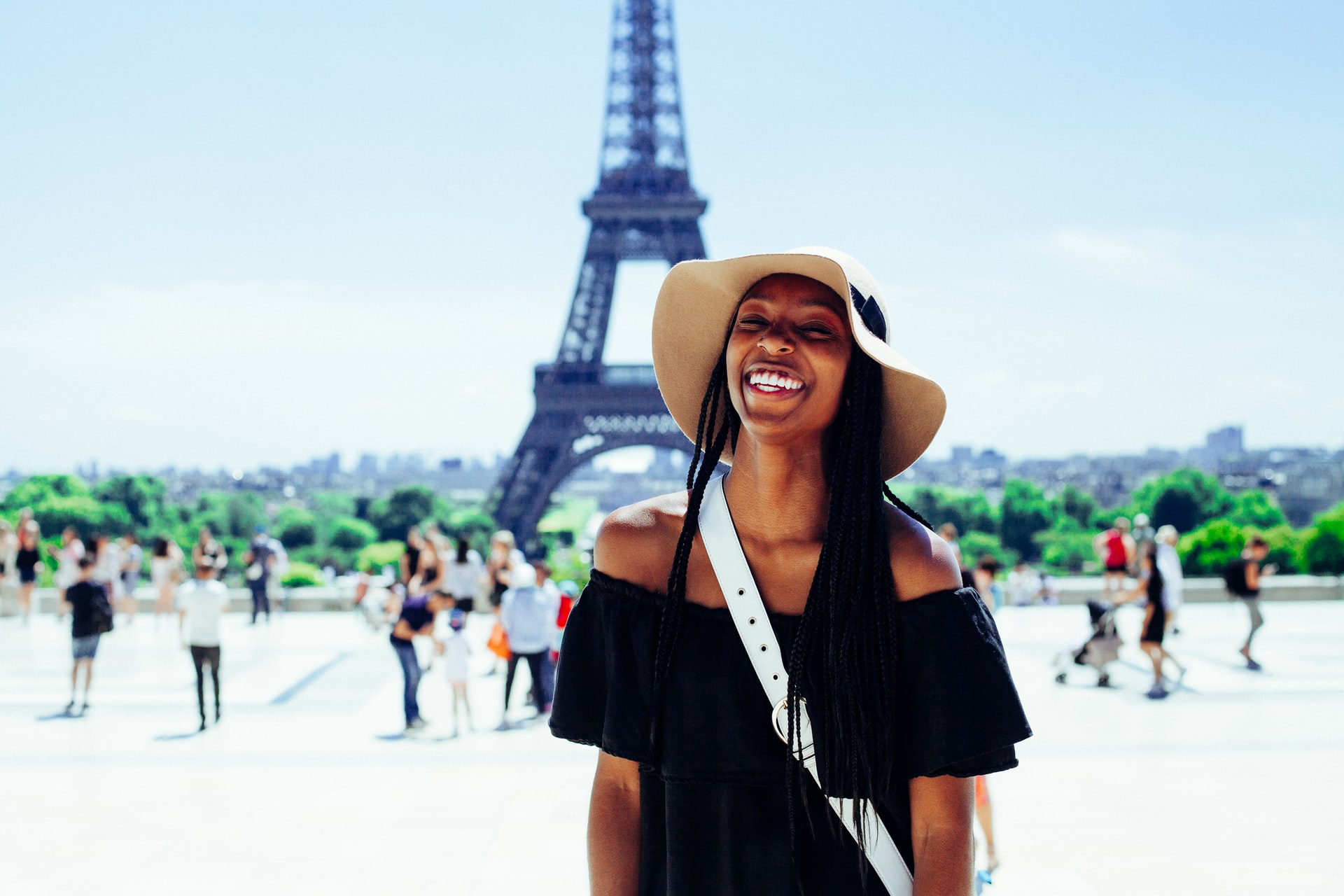 Woman smiling in front of the Eiffel Tower in Paris