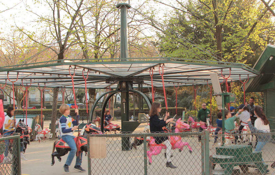 Kids on merry-go-round in Eiffel Tower gardens